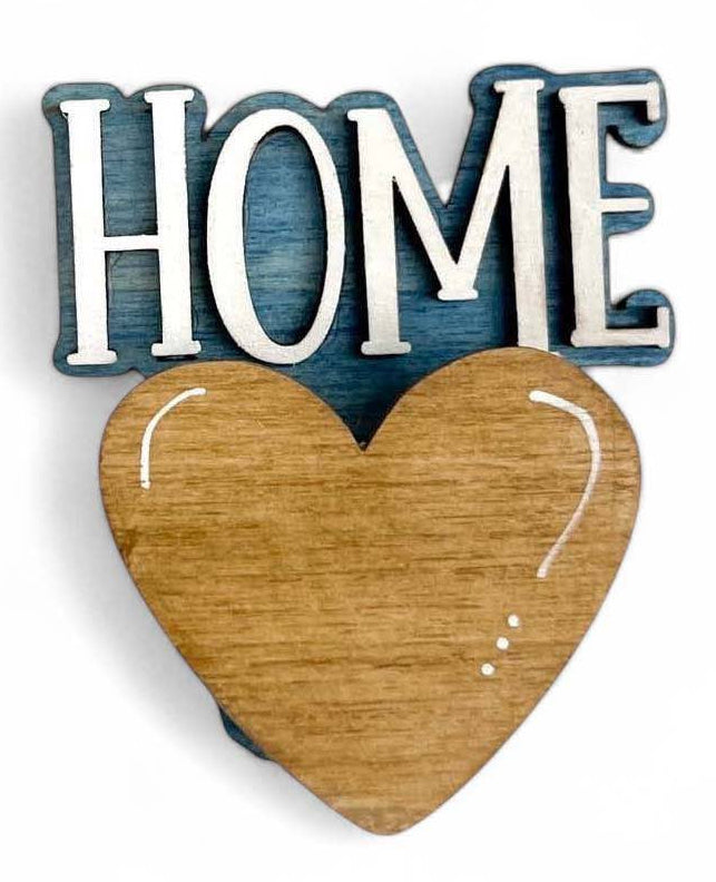 A wooden 'Mug Hugger' decoration with the text 'HOME' and a heart shape on it